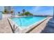 Inviting outdoor pool with a beach view, surrounded by lounge chairs at 5300 Gulf Dr # 501, Holmes Beach, FL 34217