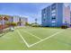 Well-maintained tennis court with surrounding palm trees, offering a recreational amenity at 5300 Gulf Dr # 501, Holmes Beach, FL 34217