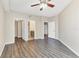 Bedroom with wood-look floors and multiple doorways including a bathroom entrance at 5552 Bentgrass Dr # 7-301, Sarasota, FL 34235