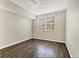 Bright bedroom features hardwood floors, large window, and ceiling fan at 5552 Bentgrass Dr # 7-301, Sarasota, FL 34235