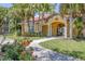 Clubhouse exterior with tropical landscaping at 5552 Bentgrass Dr # 7-301, Sarasota, FL 34235