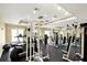 Community gym featuring mirrored wall, weight machines, elliptical machine, and treadmills at 5552 Bentgrass Dr # 7-301, Sarasota, FL 34235