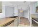 Modern kitchen with wood countertops, stainless steel appliances, and view to dining area at 5552 Bentgrass Dr # 7-301, Sarasota, FL 34235