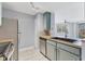 Well-lit kitchen boasts stainless steel appliances and ample counter space with a view into the living area at 5552 Bentgrass Dr # 7-301, Sarasota, FL 34235