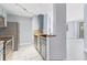 Bright kitchen featuring stainless steel appliances, light blue cabinetry, and modern countertops at 5552 Bentgrass Dr # 7-301, Sarasota, FL 34235