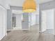 Open living space showcasing modern lighting, kitchen access, and open floor plan at 5552 Bentgrass Dr # 7-301, Sarasota, FL 34235