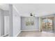 Bright living room with ceiling fan, sliding doors and wood floors at 5552 Bentgrass Dr # 7-301, Sarasota, FL 34235