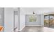 Bright living room with light walls, ceiling fan, sliding glass doors, and wood floors at 5552 Bentgrass Dr # 7-301, Sarasota, FL 34235