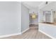 Modern living room with a view into the kitchen, wood floors and light fixtures at 5552 Bentgrass Dr # 7-301, Sarasota, FL 34235