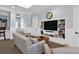 Lounge area with comfortable couches, a tv, and built-in bookshelves at 5552 Bentgrass Dr # 7-301, Sarasota, FL 34235