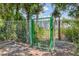 Outdoor park area with a green gated entrance. The hours of the park are posted at 5552 Bentgrass Dr # 7-301, Sarasota, FL 34235