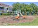 Community playground with slides and swings next to a two-story apartment building at 5552 Bentgrass Dr # 7-301, Sarasota, FL 34235