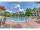 Bright community pool with brick trim and plenty of lounge chairs for relaxing in the sun at 5552 Bentgrass Dr # 7-301, Sarasota, FL 34235