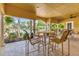 Community poolside patio includes a table and chairs at 5552 Bentgrass Dr # 7-301, Sarasota, FL 34235