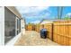 Enclosed brick backyard featuring a black grill, well maintained fencing, and view of the screened patio at 5603 1St Avenue Dr Nw, Bradenton, FL 34209