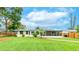 Manicured lawn, privacy fence, screened in porch and an attached home provide an inviting outdoor oasis at 5603 1St Avenue Dr Nw, Bradenton, FL 34209