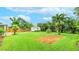Large backyard with lush tropical foliage, a storage shed, brick path, and an outdoor brick patio at 5603 1St Avenue Dr Nw, Bradenton, FL 34209
