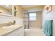 Cozy bathroom with a shower/tub combo, framed mirror, and charming wainscoting details at 5603 1St Avenue Dr Nw, Bradenton, FL 34209