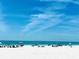 Beautiful beach view, with white sand and people enjoying the clear blue waters at 5603 1St Avenue Dr Nw, Bradenton, FL 34209