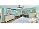 Brightly lit bedroom with dresser and vanity plus wall-mounted TV at 5603 1St Avenue Dr Nw, Bradenton, FL 34209