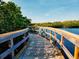 Picturesque boardwalk view with wooden railings, overlooking calm waters and green foliage at 5603 1St Avenue Dr Nw, Bradenton, FL 34209