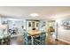 Bright dining area features a wood table, modern lighting, wood floors, and access to other rooms at 5603 1St Avenue Dr Nw, Bradenton, FL 34209