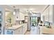 Bright kitchen boasts white cabinetry, stainless steel appliances, and a cozy breakfast nook at 5603 1St Avenue Dr Nw, Bradenton, FL 34209
