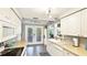 Spacious kitchen features white cabinetry, stainless appliances and doors to the patio at 5603 1St Avenue Dr Nw, Bradenton, FL 34209