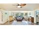 An open living room features a ceiling fan, a bay window, and views to the exterior at 5603 1St Avenue Dr Nw, Bradenton, FL 34209