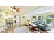 Bright and airy living room with ceiling fan, wood floors, and open access to other rooms at 5603 1St Avenue Dr Nw, Bradenton, FL 34209