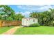 A backyard storage shed with an access ramp sits near a brick path and wood fence at 5603 1St Avenue Dr Nw, Bradenton, FL 34209