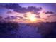 A dramatic sunset over the horizon, casting vibrant colors across the beach and sky at 5603 1St Avenue Dr Nw, Bradenton, FL 34209