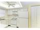 Functional kitchen featuring white appliances, ample cabinet space, and an overhead ceiling fan at 6030 7Th W Ave # 6030, Bradenton, FL 34209