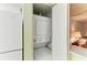 Convenient laundry closet featuring a stacked washer and dryer, optimizing space and functionality at 6030 7Th W Ave # 6030, Bradenton, FL 34209