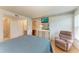 Bright main bedroom with a wall-mounted television, a comfortable recliner, and wood-look floors at 6030 7Th W Ave # 6030, Bradenton, FL 34209