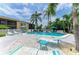 Outdoor pool area with lounge chairs, tables, palm trees and well-kept landscaping at 6030 7Th W Ave # 6030, Bradenton, FL 34209