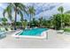 Outdoor pool area with lounge chairs, tables, palm trees and shade umbrellas at 6030 7Th W Ave # 6030, Bradenton, FL 34209