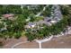 An aerial view of townhomes with golf course frontage and mature trees in a lush golf course community at 6110 Country Club Way # 102, Sarasota, FL 34243