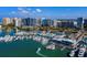 Breathtaking aerial view of a marina filled with boats and yachts against a backdrop of city skyline at 6110 Country Club Way # 102, Sarasota, FL 34243