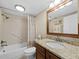 Cozy bathroom featuring a tub with shower, granite vanity, and neutral-toned tile at 6110 Country Club Way # 102, Sarasota, FL 34243