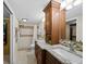 Bathroom with double sinks, granite counters, and tiled walk-in shower at 6110 Country Club Way # 102, Sarasota, FL 34243