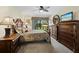 Comfortable bedroom showcasing a large window, ceiling fan, and wood furniture at 6110 Country Club Way # 102, Sarasota, FL 34243