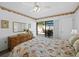 Charming bedroom featuring dresser, mirror, and sliding glass door access to the outdoor patio area at 6110 Country Club Way # 102, Sarasota, FL 34243