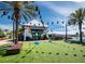Charming brewery featuring outdoor seating, string lights, recreational area, and picturesque landscaping near the water at 6110 Country Club Way # 102, Sarasota, FL 34243