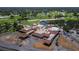 An aerial view of the clubhouse, featuring lush surroundings and golf cart parking, highlights the community's amenities at 6110 Country Club Way # 102, Sarasota, FL 34243