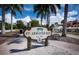 Welcome to St. Armands Key, featuring lush landscaping, mature palm trees, and a quaint community sign at 6110 Country Club Way # 102, Sarasota, FL 34243