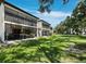 Building exterior with lush green lawn at 6110 Country Club Way # 102, Sarasota, FL 34243