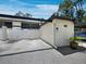 Well-maintained townhome featuring a private fenced patio and carport surrounded by lush landscaping and mature trees at 6110 Country Club Way # 102, Sarasota, FL 34243