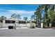 Well-maintained townhomes featuring private fenced patios and carports surrounded by lush landscaping and mature trees at 6110 Country Club Way # 102, Sarasota, FL 34243
