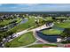 Aerial view showcasing the lush golf course, serene lakes, and verdant landscapes of the community at 6110 Country Club Way # 102, Sarasota, FL 34243